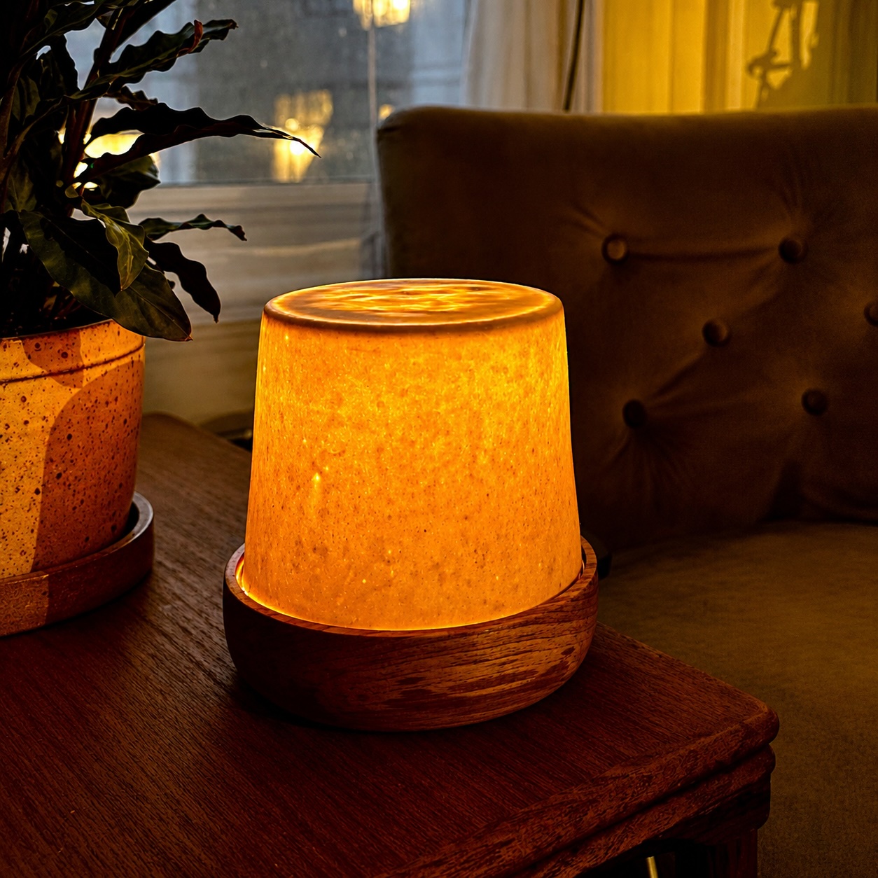 Lamp with a wood base and translucent porcelain shade