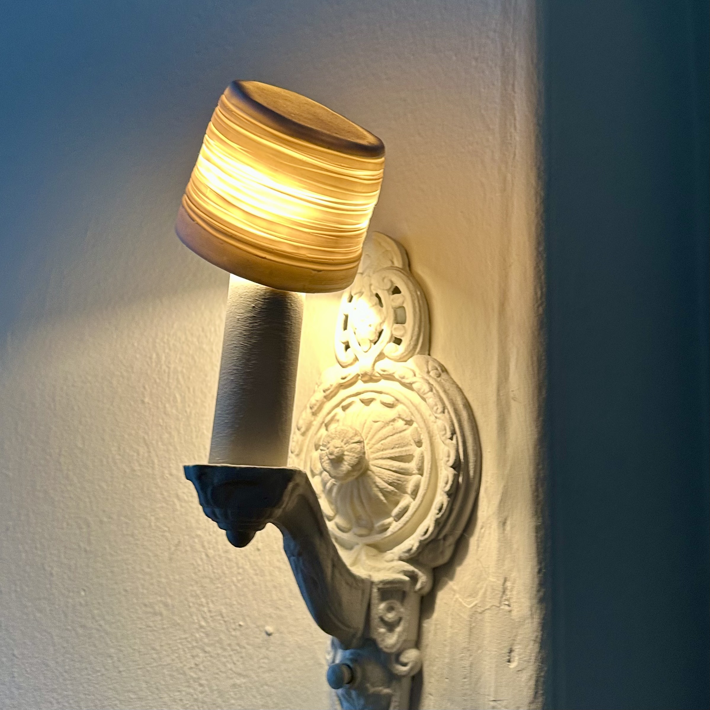 Translucent porcelain cup placed on top of a light fixture — proof of concept